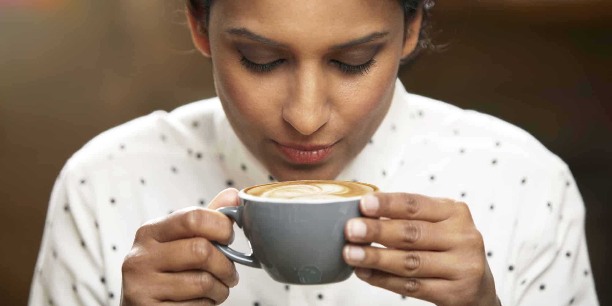 Woman about to drink a cup of coffee.