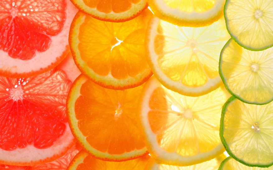 Sliced citrus fruits background (grapefruit, orange, lemon, lime)